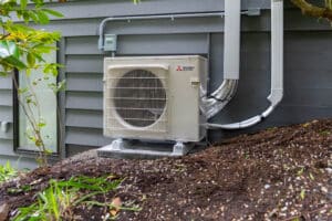 Mitsubishi mini split condenser on dark dirt