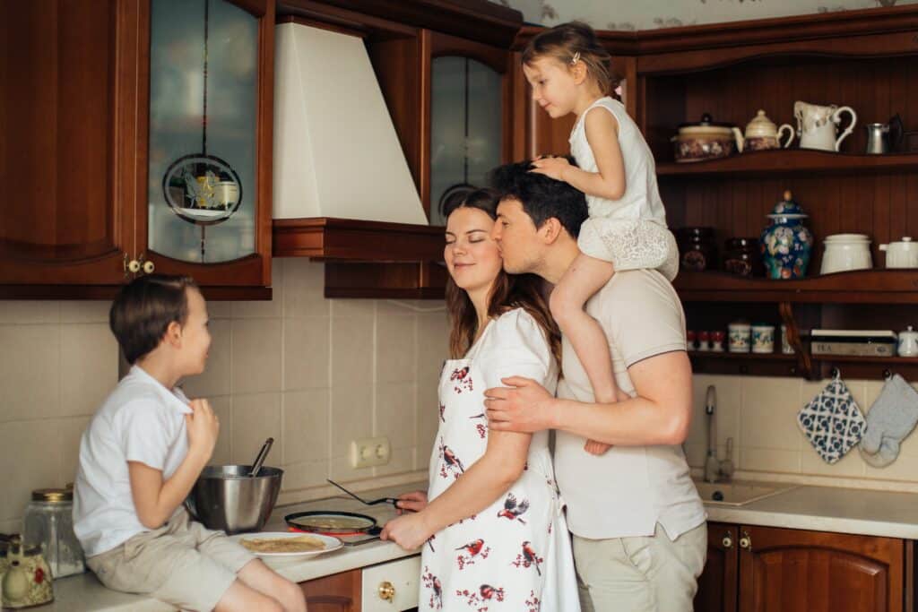 Family Cooking Crepes In A Kitchen