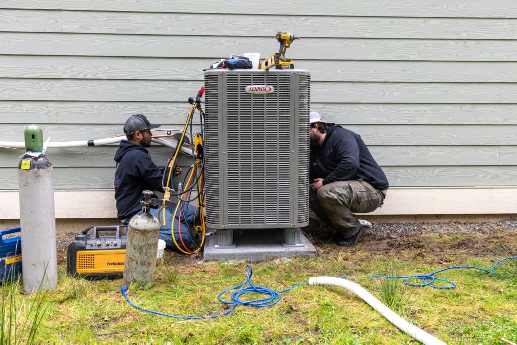 Two Employees Working On Lennox Unit
