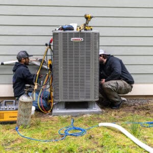 Two Employees Working On Lennox Unit