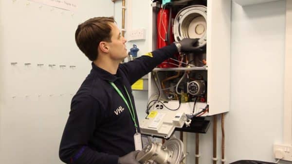 A man Servicing A Boiler Wall Unit