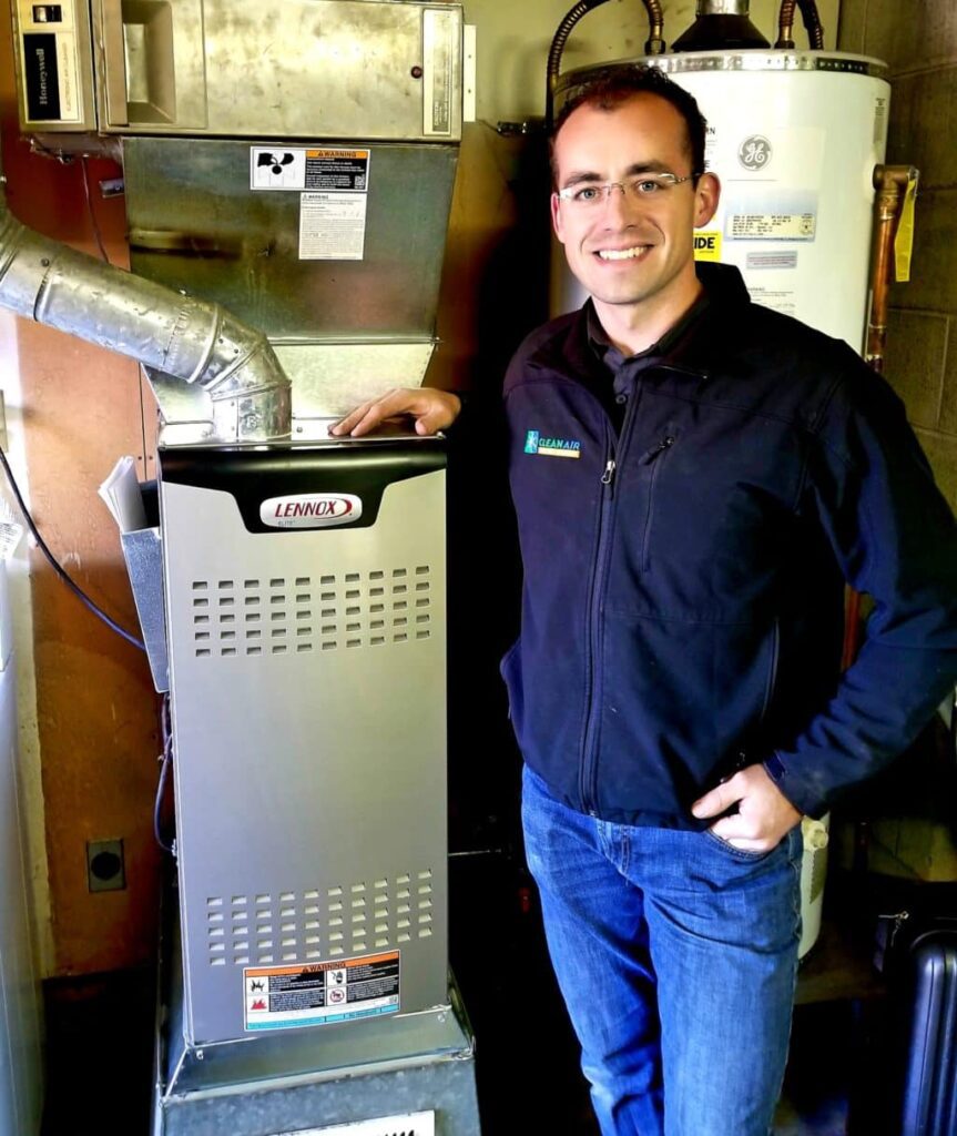 Owner of Clean Air standing next to a furnace