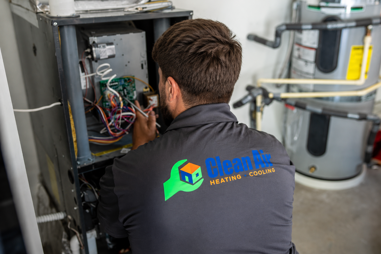 Clean Air HVAC technician working on equipment in a Bellingham home